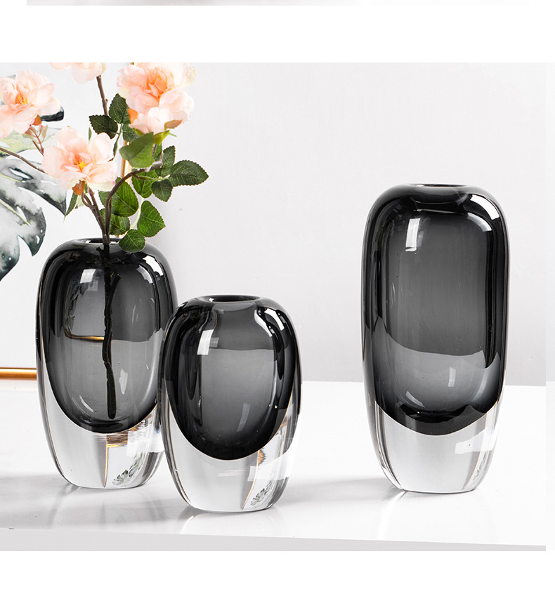 Smoky glass vases with pink roses in a bright room