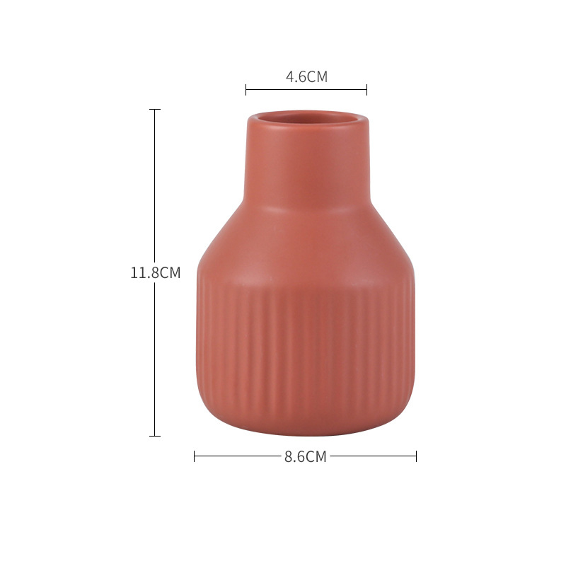 Ribbed vase with fresh stems on a styled tabletop