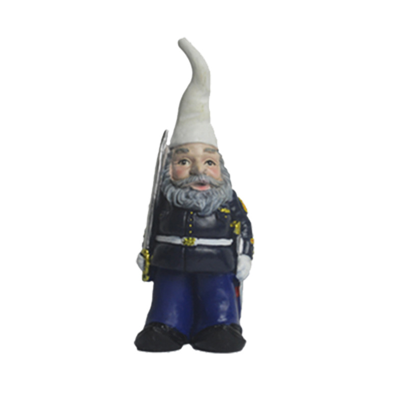 Group of painted resin gnomes in mixed costumes standing together outdoors