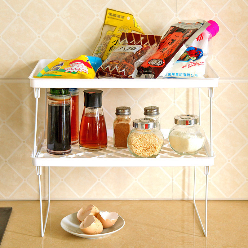 Glass spice jars and sauce bottles resting on the lower tier of a white rack