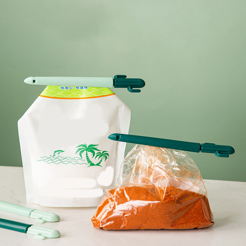 Two cactus clips clamping a stand-up pouch and a plastic bag of paprika