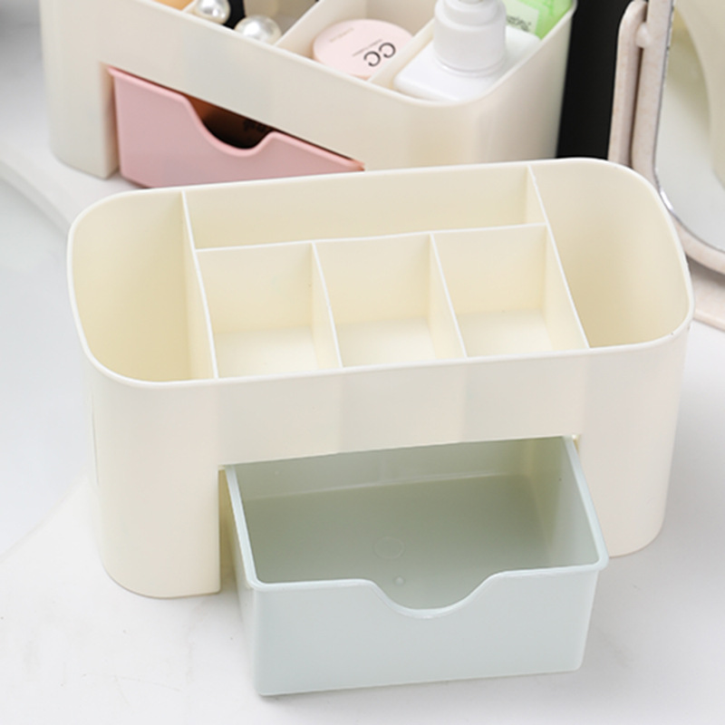 Empty cream organizer with four divider compartments and open mint drawer