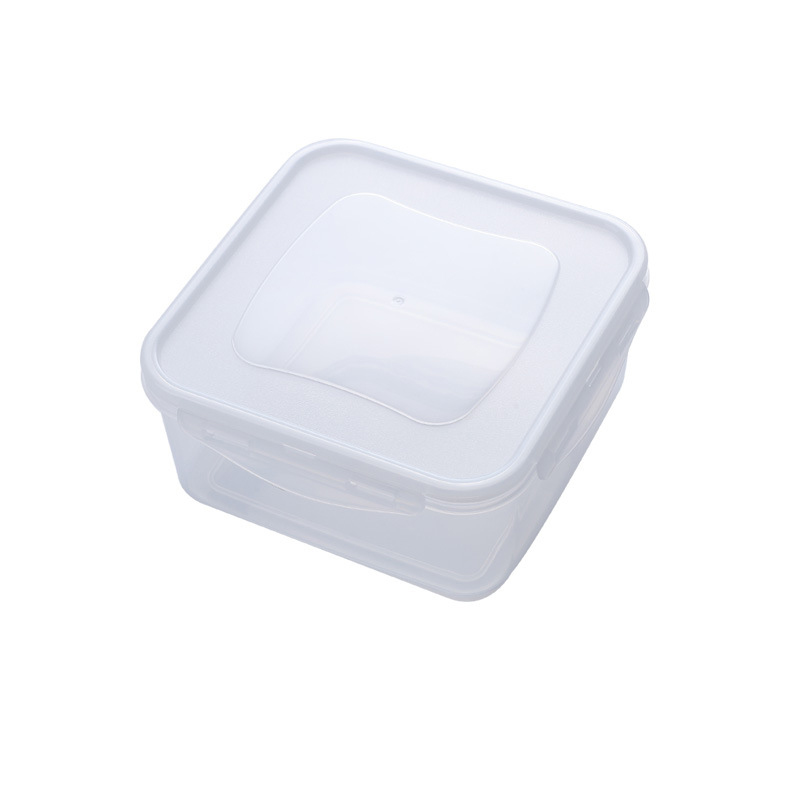 Hands resting near a clear plastic box with a white lid on a kitchen counter