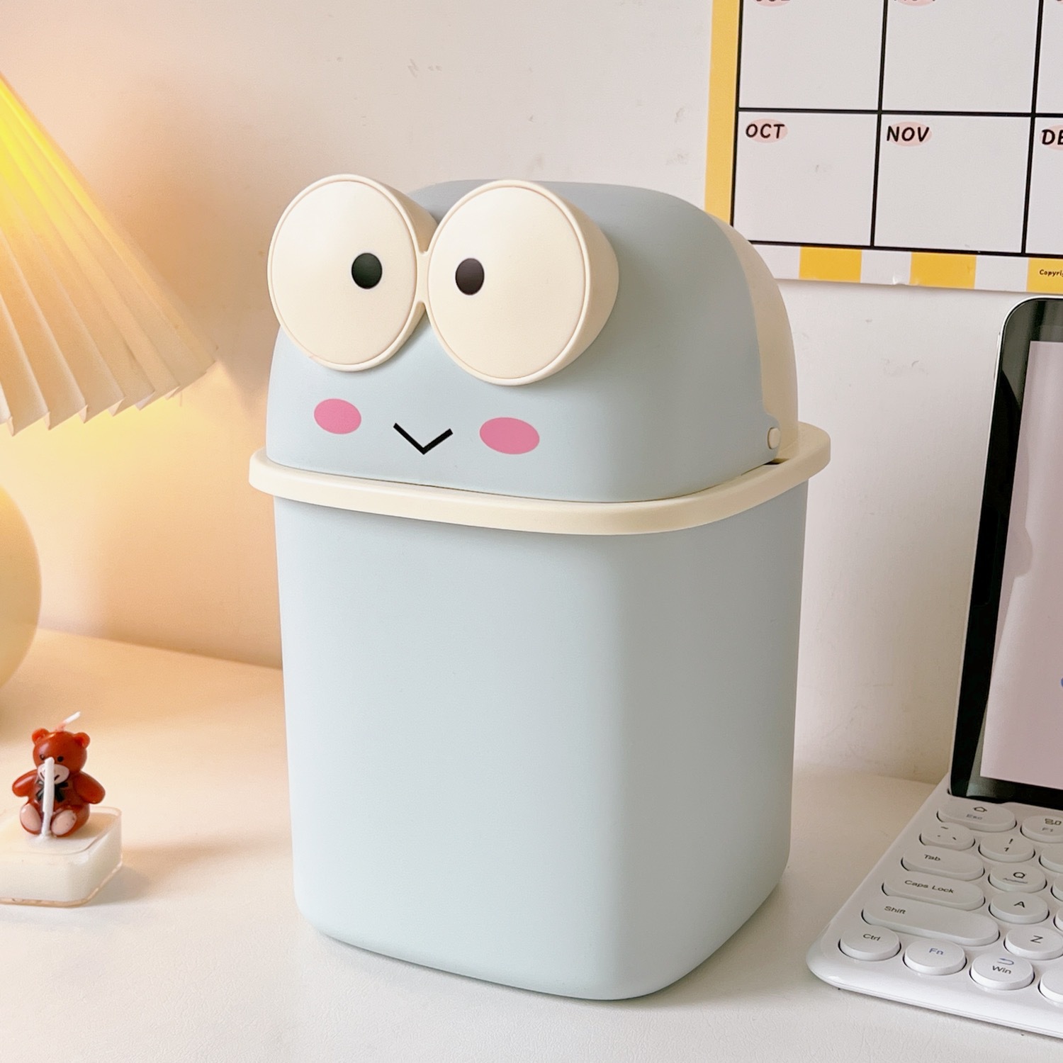 Powder blue frog desk trash can with cream rim and smile detail