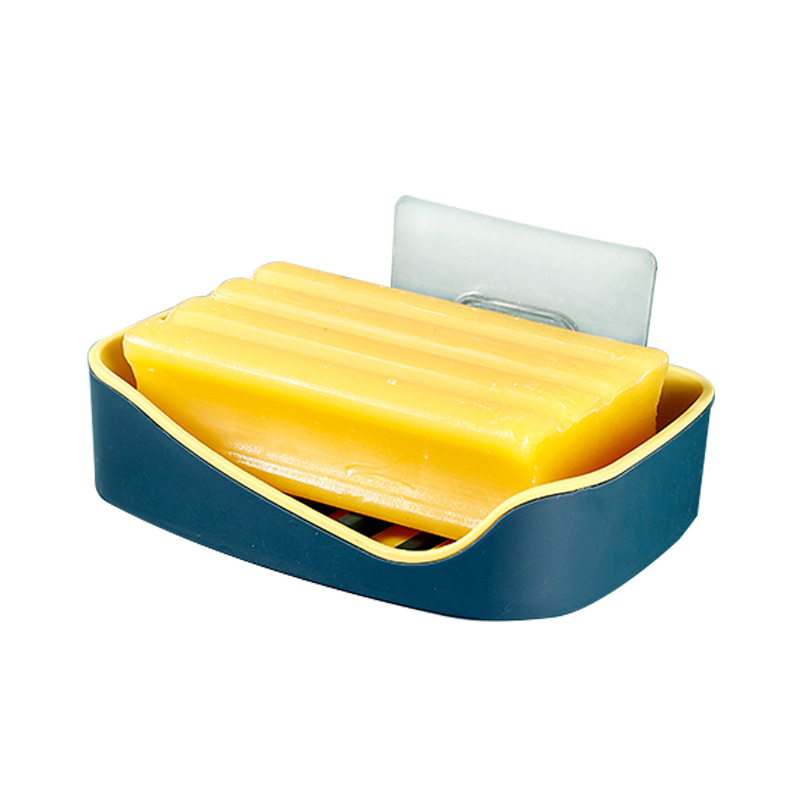 Blue and yellow soap box with raised drainage ridges holding yellow bars