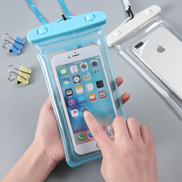 Finger tapping a phone screen through the clear film of a blue pouch
