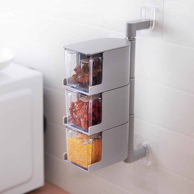 Grey seasoning unit with three stacked clear drawers holding star anise, chili and corn