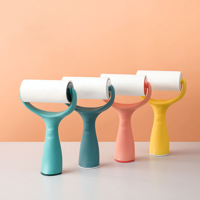 Four lint rollers in teal, sage, coral and yellow lined up together