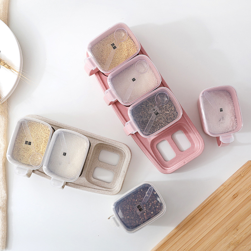 Overhead view of seasoning jars with open lids and spoons in place