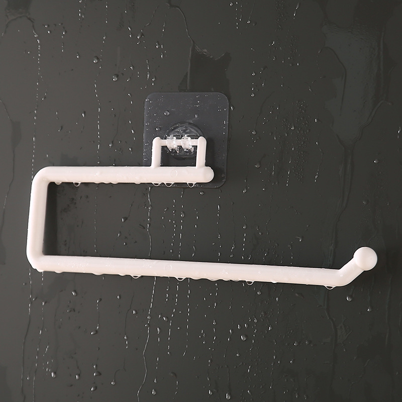 White plastic wall bar with adhesive mount on a damp tile wall