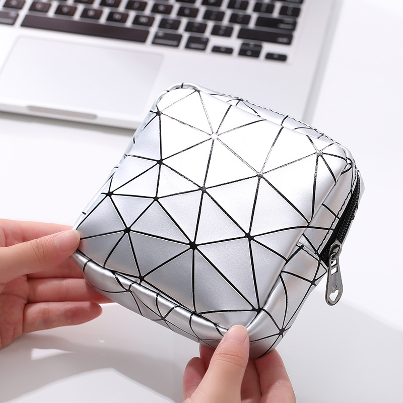 Loose sanitary pads tumbling around in a bag next to keys