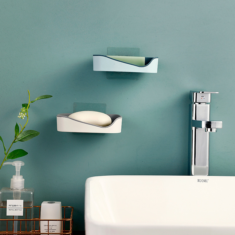 Wall-mounted soap box above a bathroom sink on a tiled wall