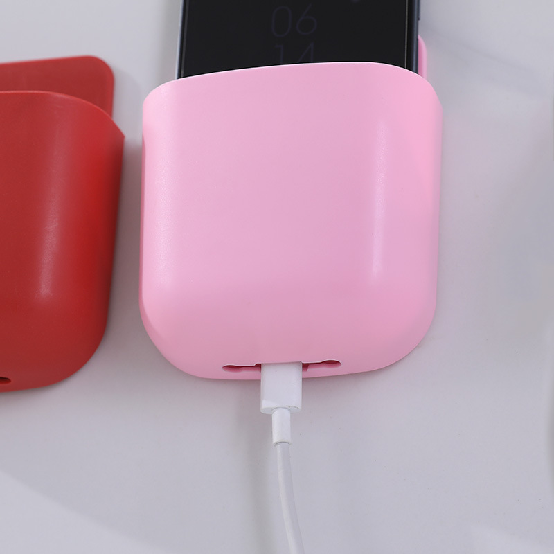Close-up of pink pocket with white charging cable leaving through the base slot