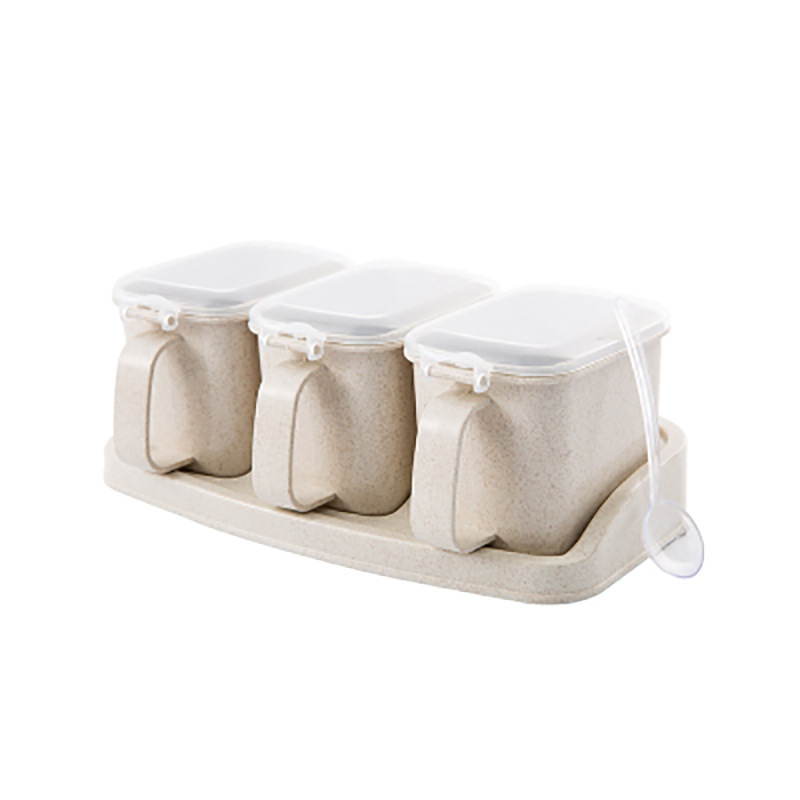 Beige three-jar seasoning set with clear lids and spoon on a matching tray