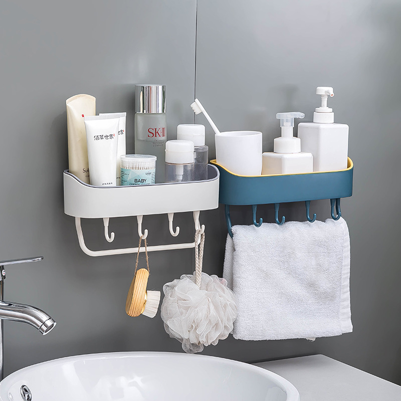 White and navy wall racks holding toiletries and towels above a bathroom sink