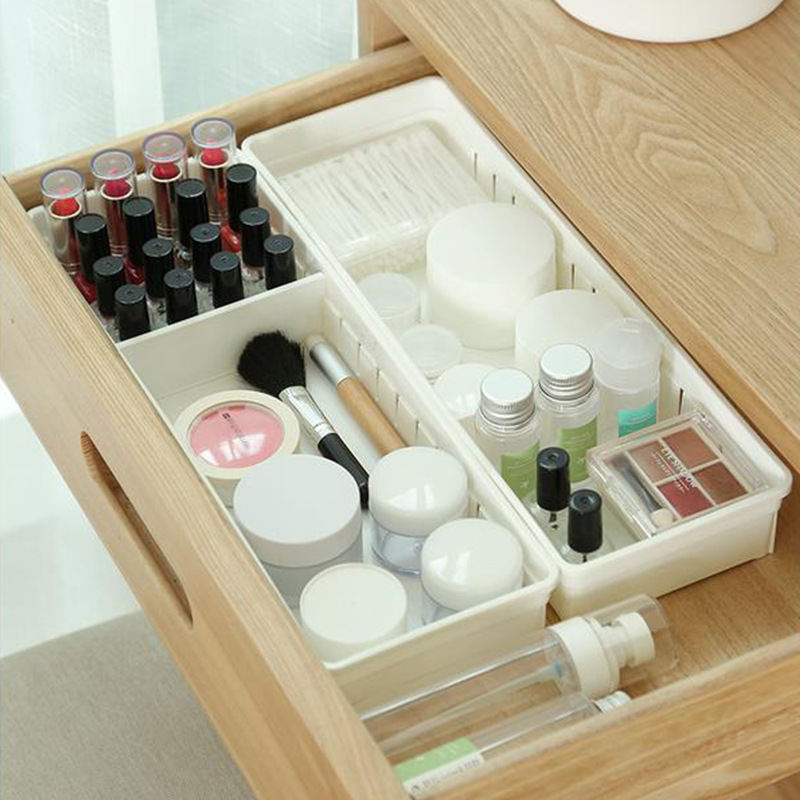Vanity drawer with lipsticks and jars standing in separate compartments