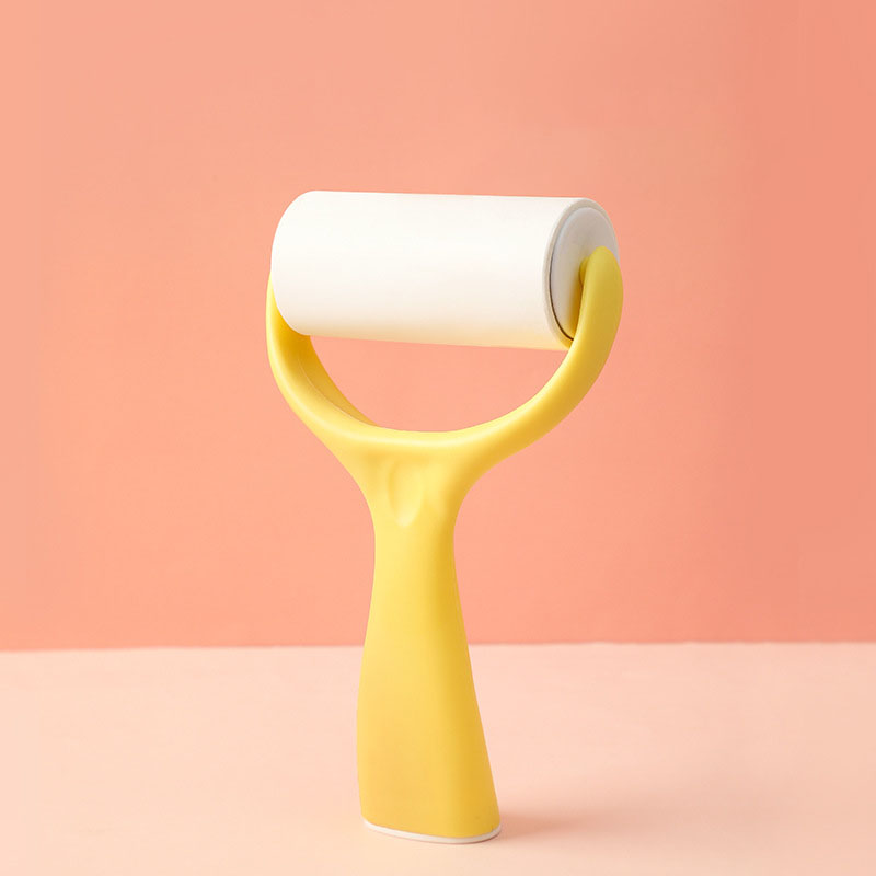 Yellow lint roller with curved handle showing the roller attachment