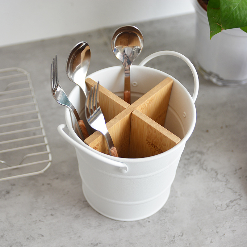 Top-down view of white metal bucket showing bamboo cross dividers and side handle