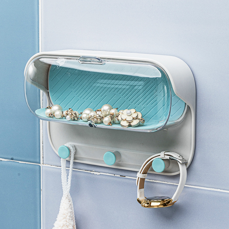 Open clear lid showing jewelry resting in the teal tray with grooves