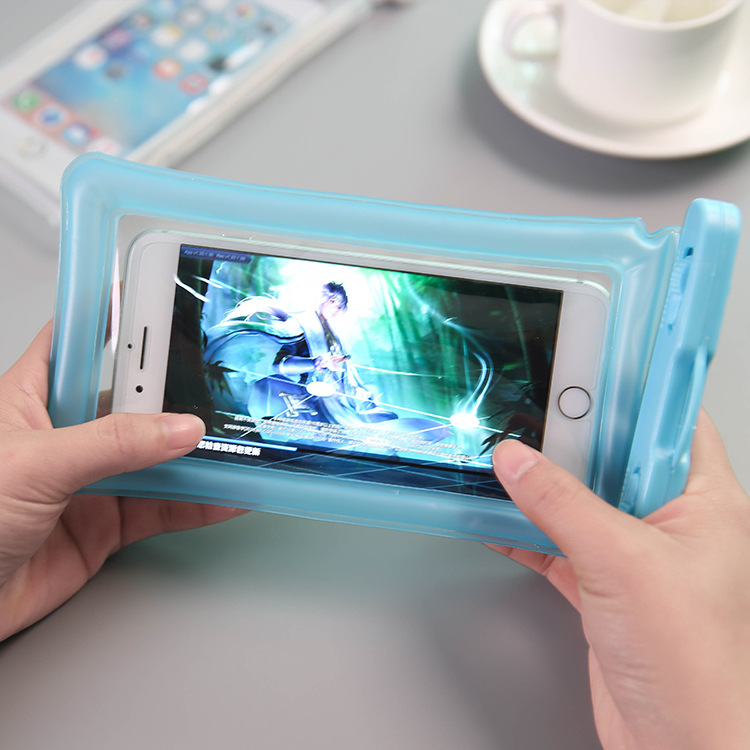 Blue pouch held landscape with a phone inside showing a game