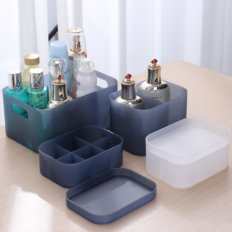 Navy and white storage boxes with a divided insert and separate lid on a table