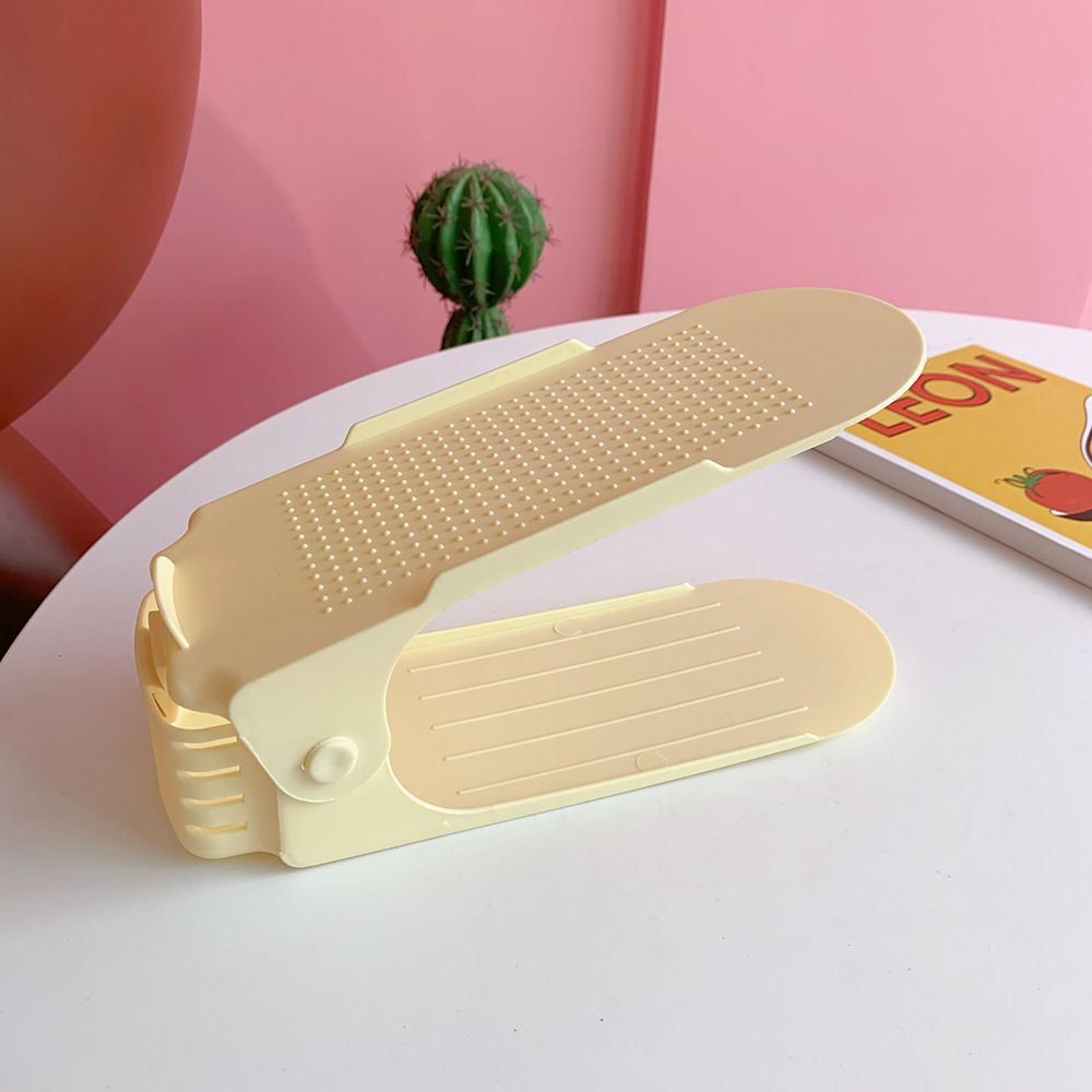 Single butter-yellow adjustable shoe rack with raised top platform, open