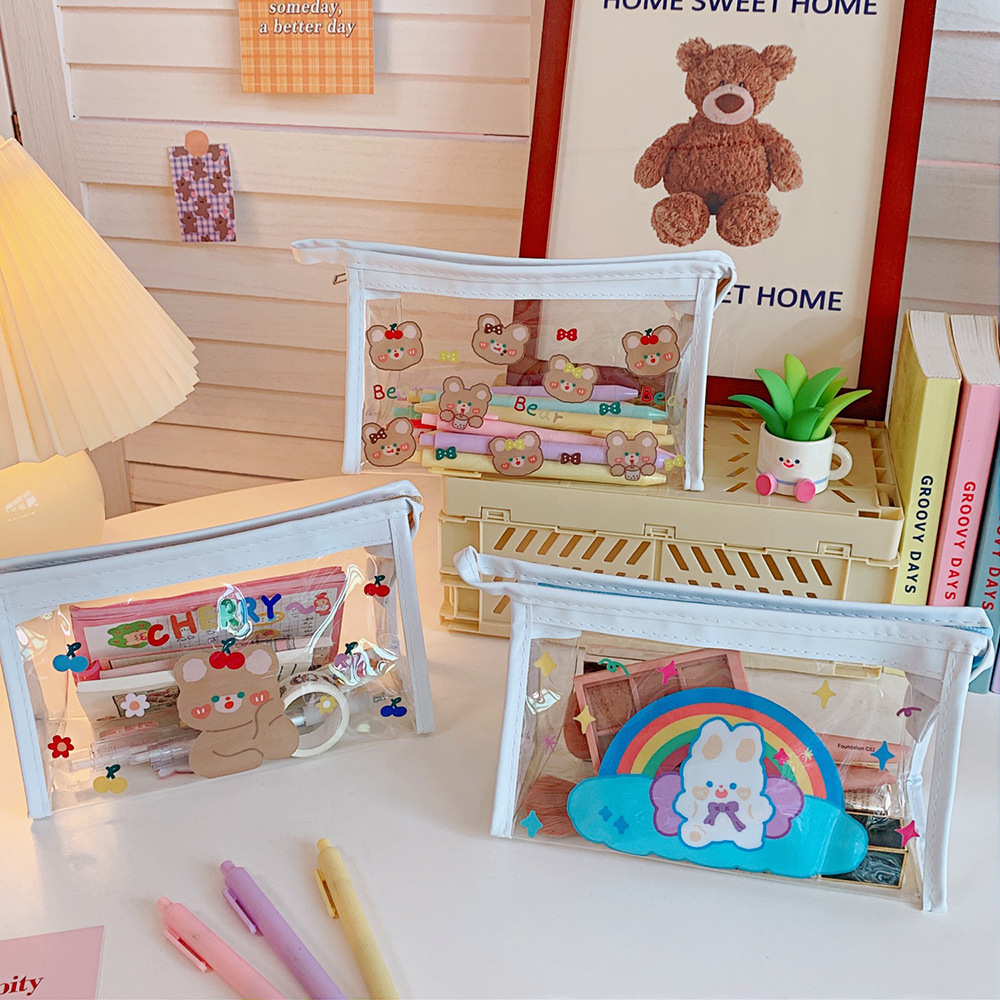 Clear pouch filled with pens, stickers and tape sitting on a desk