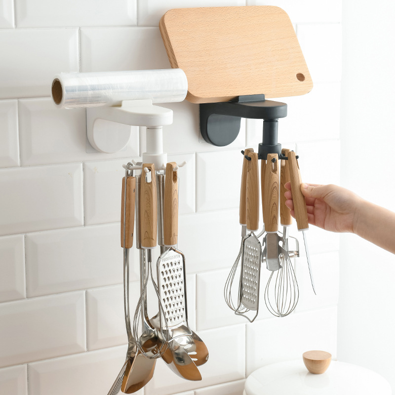 Hand turning the swivel arm while utensils hang within easy reach