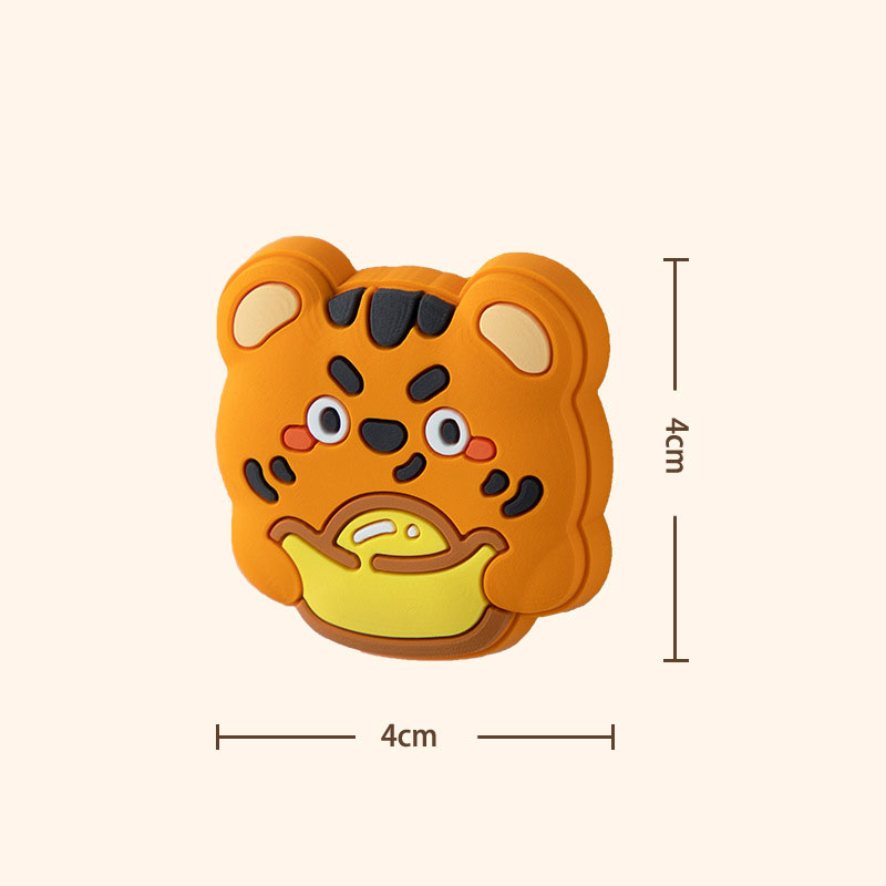 Close-up of a tiger silicone pad showing raised face detail and 4 cm size