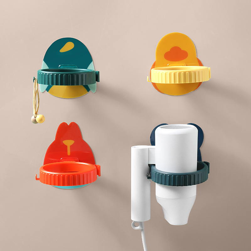 Wall-mounted holders in green, yellow and red on a beige wall with a dryer fitted