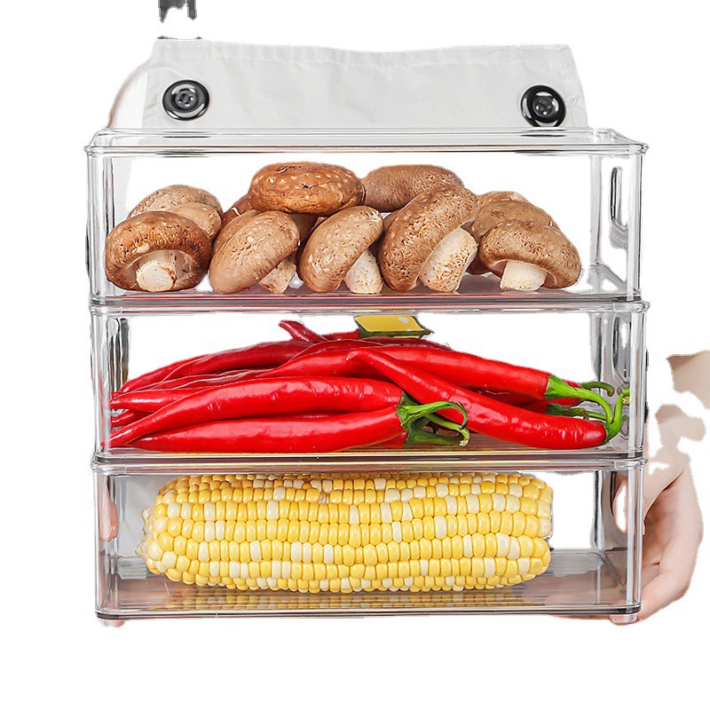 Stacked clear bins holding mushrooms, chilies and corn on a white background