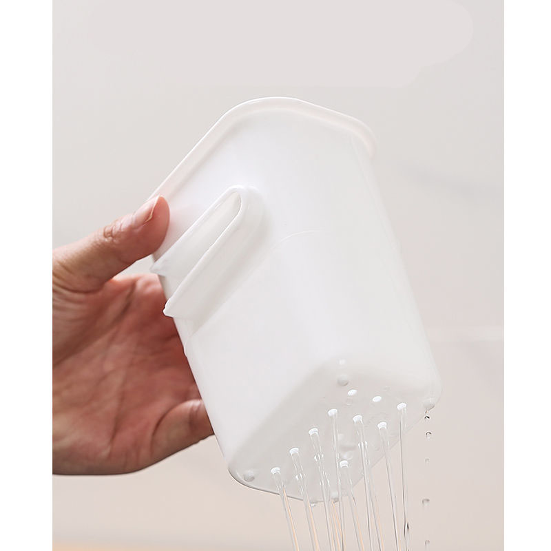 White cup with water running out through its perforated base