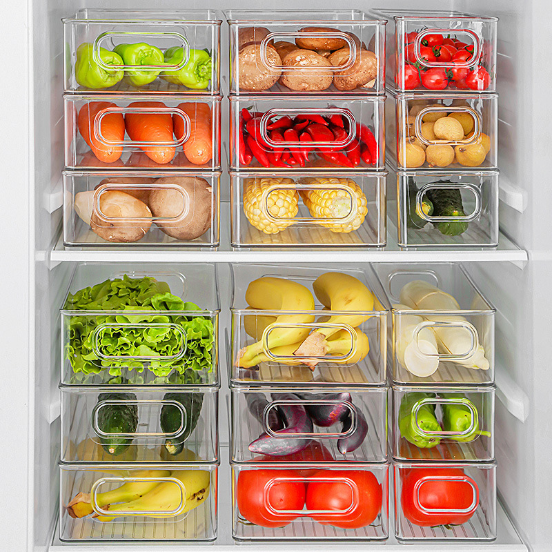 Clear fridge bins filled with peppers, potatoes, corn and lettuce on two shelves