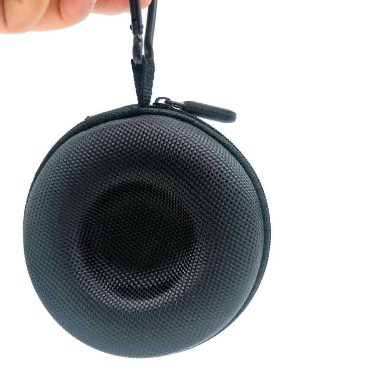 Hand holding black round watch case by its carabiner clip