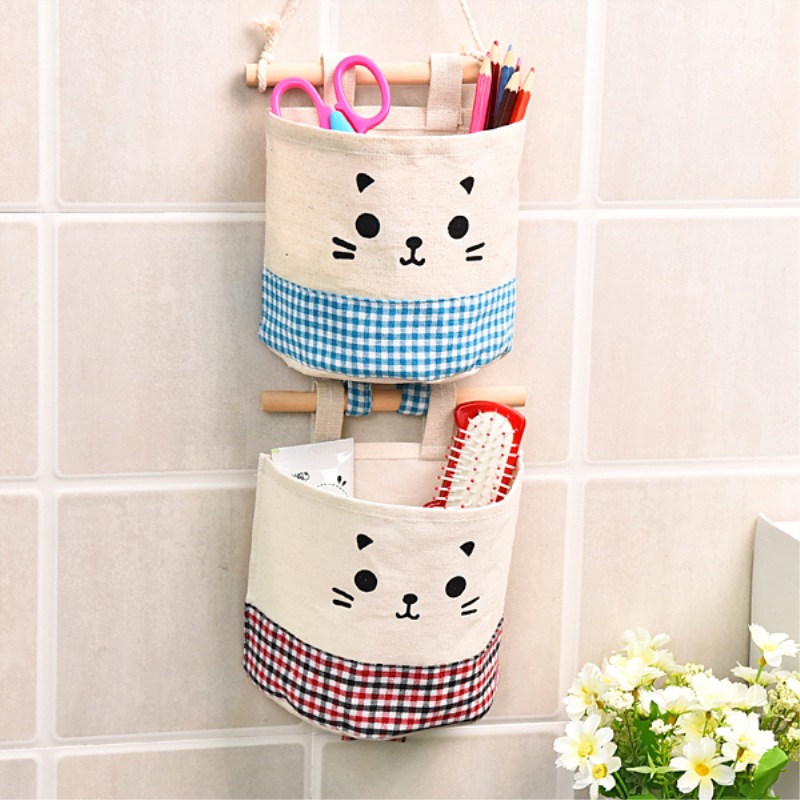 Hanging pocket holding scissors, colored pencils and a hairbrush on a tiled wall