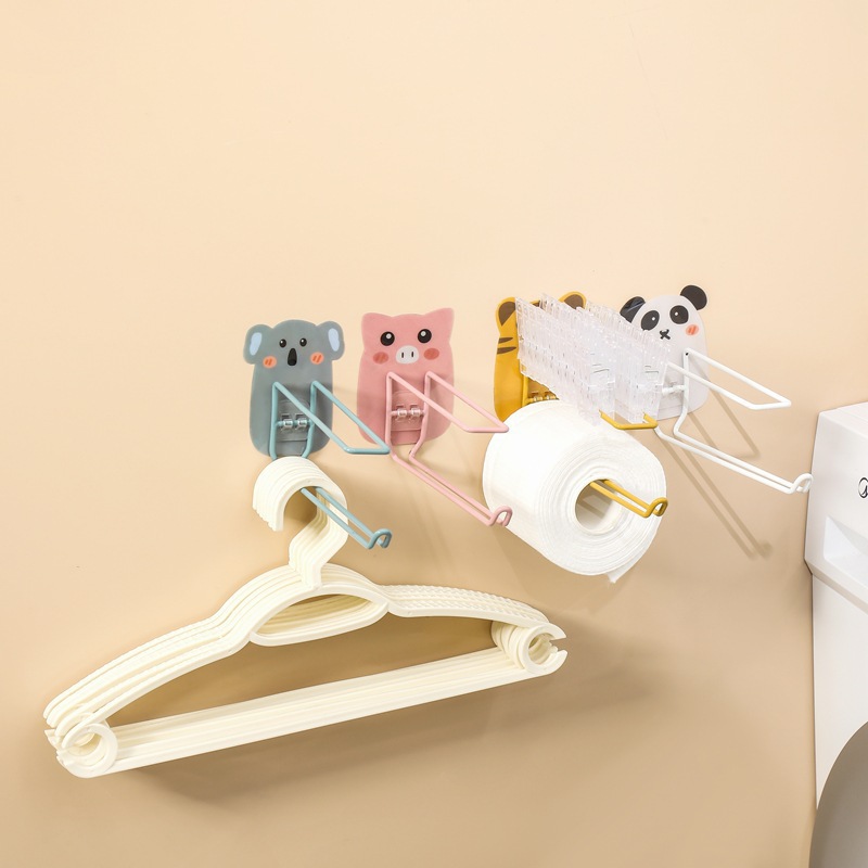 Koala, pig, tiger and panda hooks mounted in a row in a bathroom
