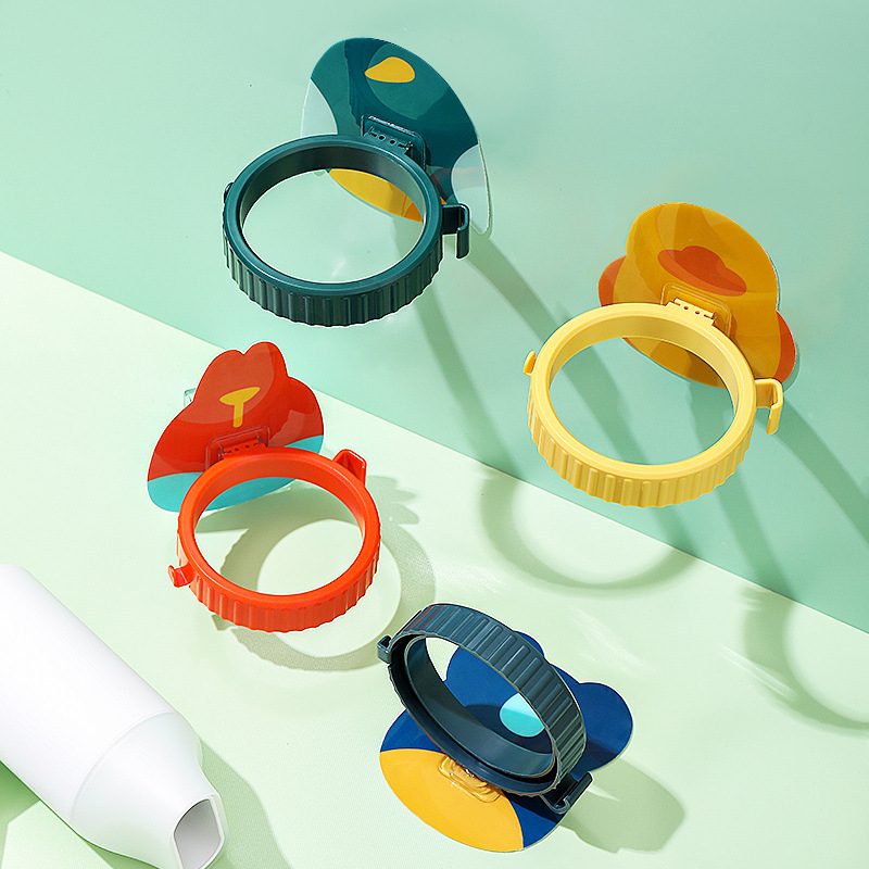 Four cartoon-backed dryer holders in green, yellow, red and blue on a mint backdrop