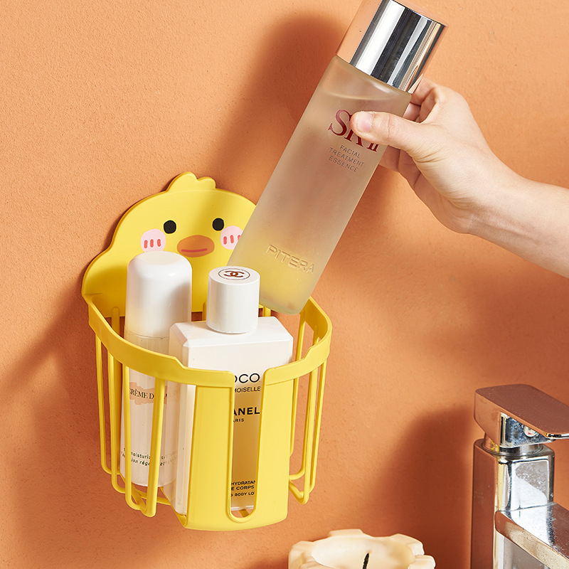 Chick cup holder on a bathroom wall holding skincare bottles