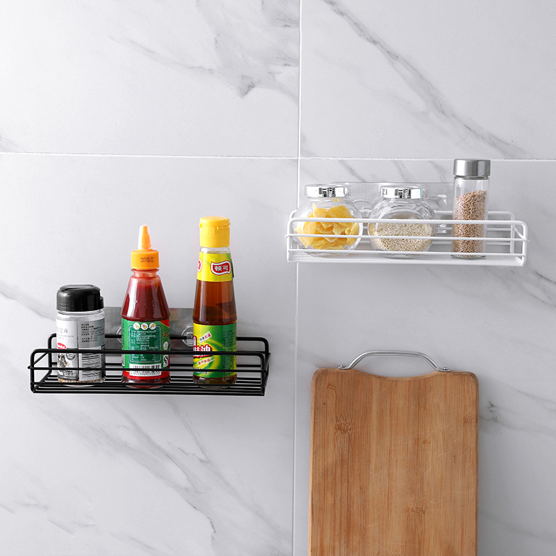 Kitchen wall racks with open wire base holding condiment bottles and spice jars