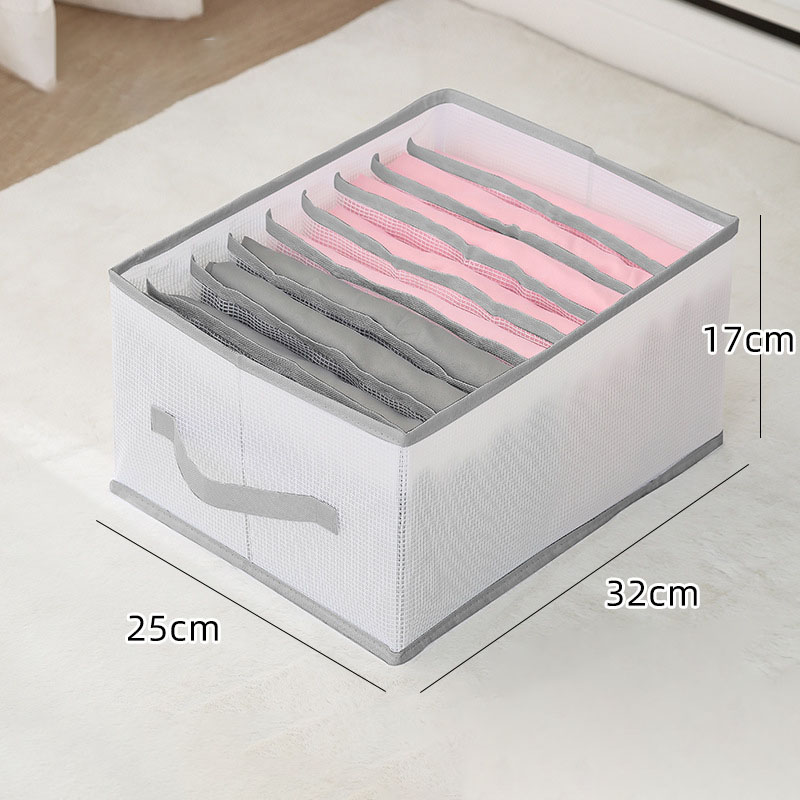 Neatly organized wardrobe drawer with upright folded trousers