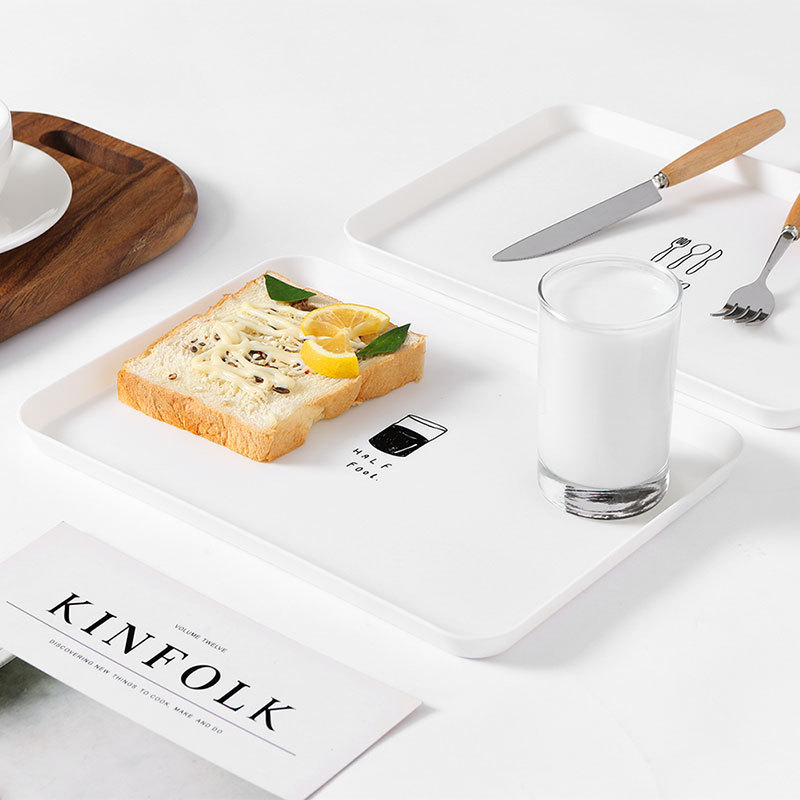 Toast and lemon on a white rectangular plate with HALF FAT print
