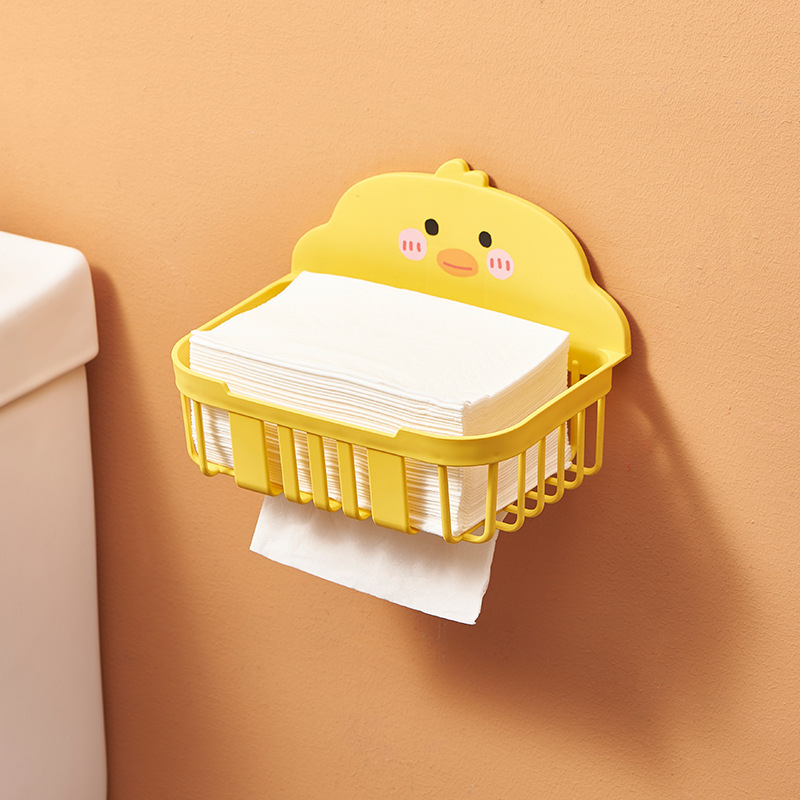 Open wire basket holding folded facial tissues beside a toilet