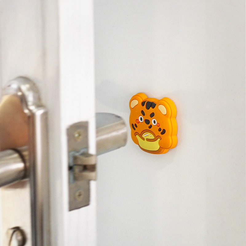 Tiger silicone pad mounted on a white door beside a silver lever handle