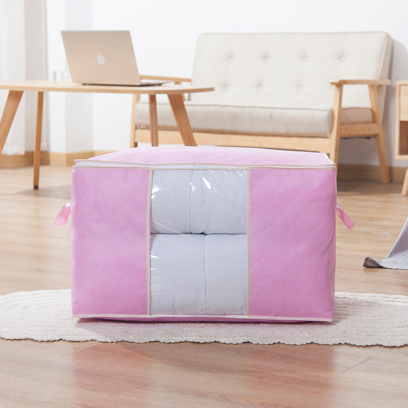 Quilt storage bag being filled with a folded quilt