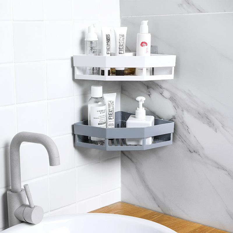 Corner rack over a bathroom sink with white top tier and grey lower tier