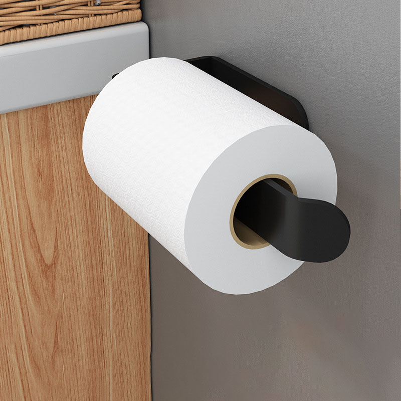 Close-up of black roll holder arm inserted in a paper roll on a wall