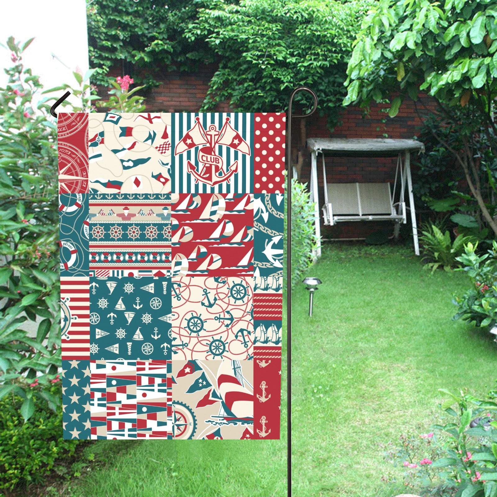 USA-made 28x40 inch garden flag with nautical patchwork design, weather-resistant, displayed outdoors.