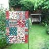 USA-made 28x40 inch garden flag with nautical patchwork design, weather-resistant, displayed outdoors.