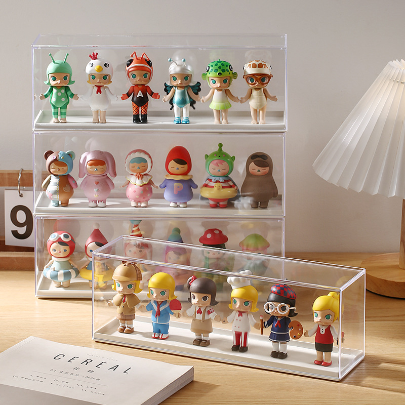 Tidy desk display of collectible figures in clear cases