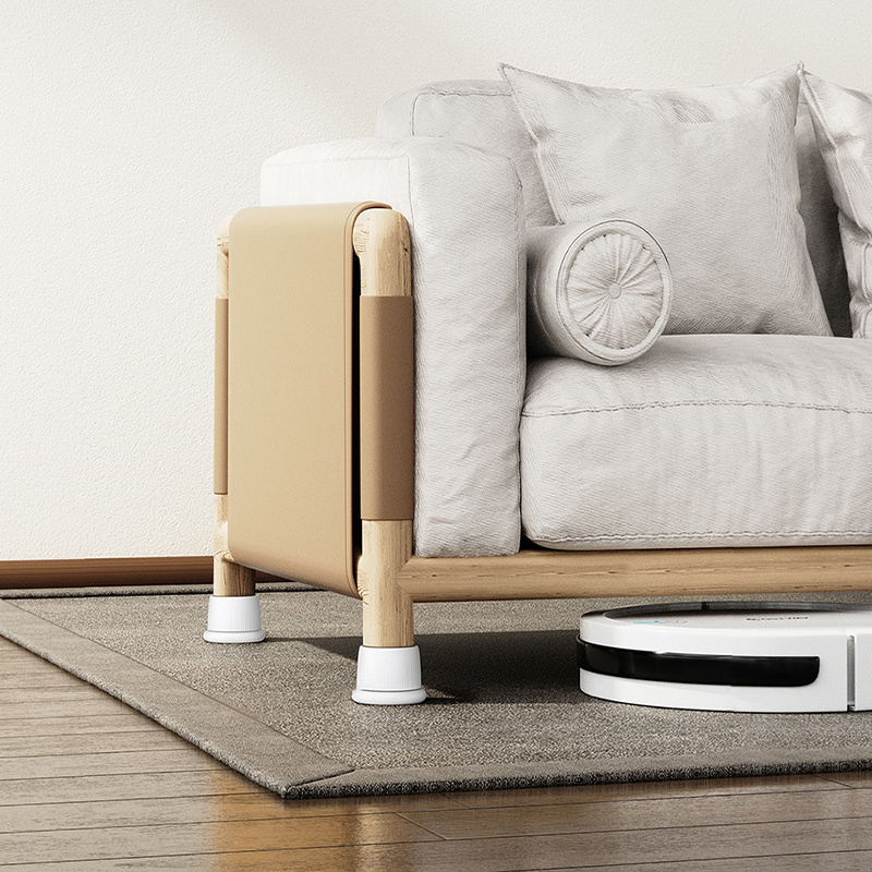 Wooden-legged sofa raised on adjustable pads with a robot vacuum passing underneath